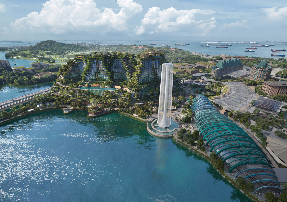 Aerial view of a resort area with greenery, modern buildings, and waterfront.